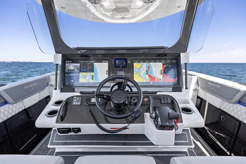  Yacht Photos Pics 2026 Mystic Powerboats M4200 helm with advanced navigation displays on open water.
