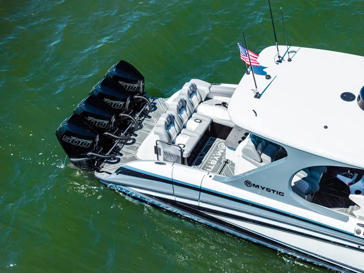  Yacht Photos Pics 2026 Mystic Powerboats M4200 with quad engines cruising on water.