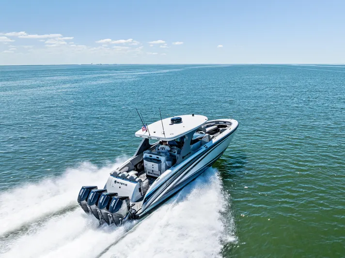  Yacht Photos Pics 2026 Mystic Powerboats M4200 speeding on open water under clear skies.