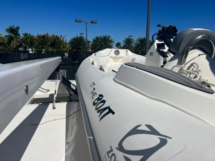 Room Service Yacht Photos Pics 2003 West Bay 68 yacht with inflatable boat on deck, under clear blue sky.