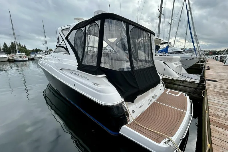  Yacht Photos Pics 2011 Regal 38 Express yacht docked at marina under cloudy skies.