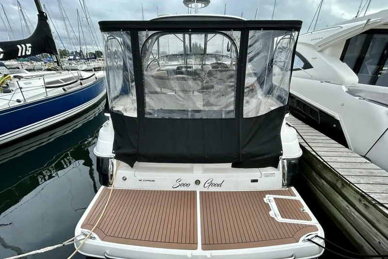  Yacht Photos Pics 2011 Regal 38 Express yacht docked, featuring a covered cockpit and wooden deck.