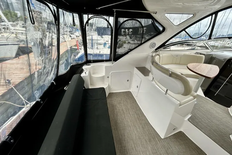  Yacht Photos Pics 2011 Regal 38 Express yacht interior with seating and table, docked at marina.
