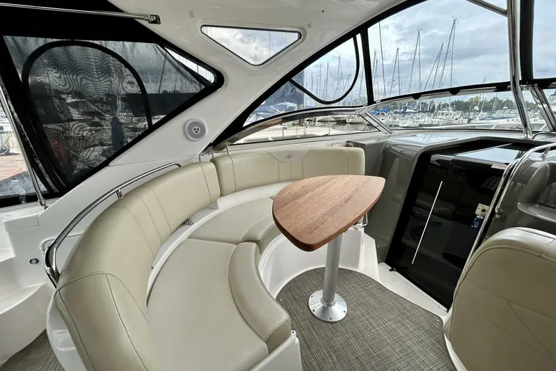  Yacht Photos Pics Luxurious interior of 2011 Regal 38 Express yacht with curved seating and wooden table.
