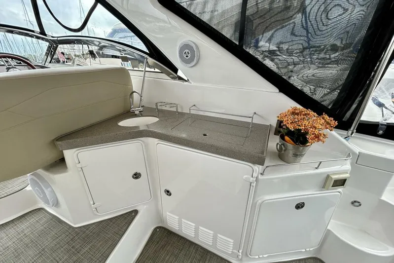  Yacht Photos Pics 2011 Regal 38 Express yacht interior with kitchenette and floral decor.