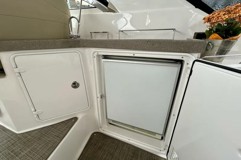  Yacht Photos Pics 2011 Regal 38 Express yacht kitchenette with sink, fridge, and floral decor.