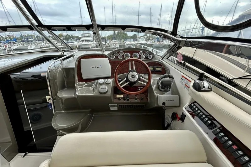 Yacht Photos Pics Cockpit of 2011 Regal 38 Express yacht with Garmin navigation system and wood-accented steering wheel.