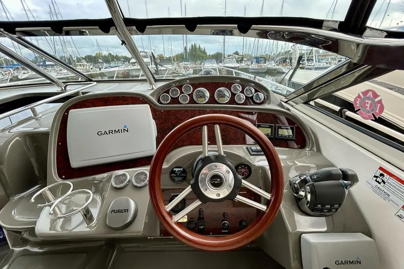  Yacht Photos Pics 2011 Regal 38 Express helm with Garmin navigation and wood-accented steering wheel.