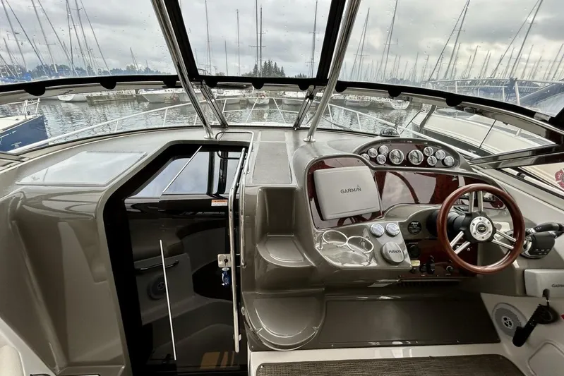  Yacht Photos Pics 2011 Regal 38 Express boat helm with Garmin navigation, docked in a marina.