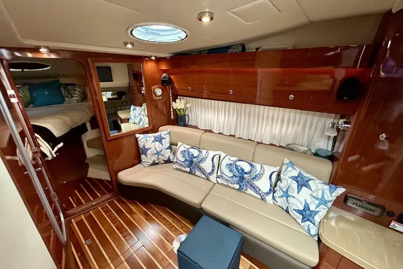  Yacht Photos Pics Luxurious 2011 Regal 38 Express yacht interior with elegant wood finish and starfish-themed decor.