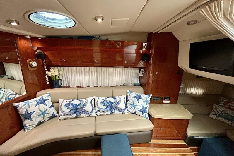  Yacht Photos Pics Luxurious interior of 2011 Regal 38 Express yacht with plush seating and nautical-themed decor.