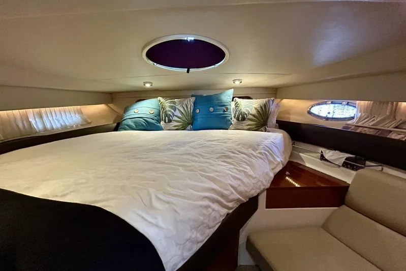  Yacht Photos Pics Luxurious cabin interior of 2011 Regal 38 Express yacht with cozy bedding and ambient lighting.