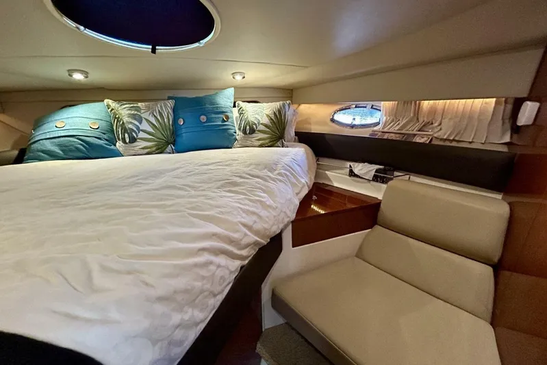  Yacht Photos Pics Luxurious 2011 Regal 38 Express cabin interior with cozy bed and stylish decor.