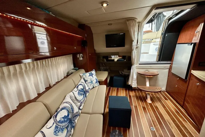  Yacht Photos Pics Luxurious interior of 2011 Regal 38 Express yacht with elegant wood finishes and cozy seating.