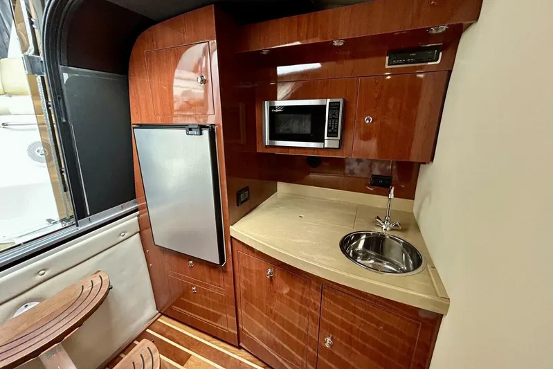  Yacht Photos Pics 2011 Regal 38 Express yacht interior kitchen with microwave, fridge, and sink.