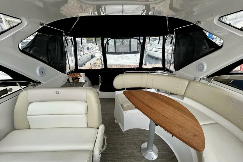  Yacht Photos Pics Interior of 2011 Regal 38 Express yacht with elegant seating and wooden table.