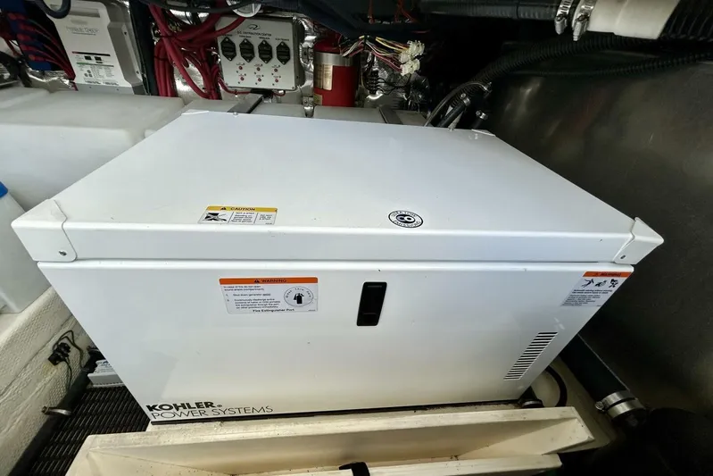  Yacht Photos Pics Kohler power system in 2011 Regal 38 Express engine room, surrounded by wiring and components.