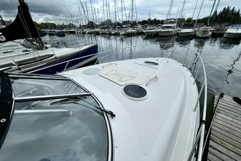  Yacht Photos Pics 2011 Regal 38 Express yacht docked at marina with sailboats in background.