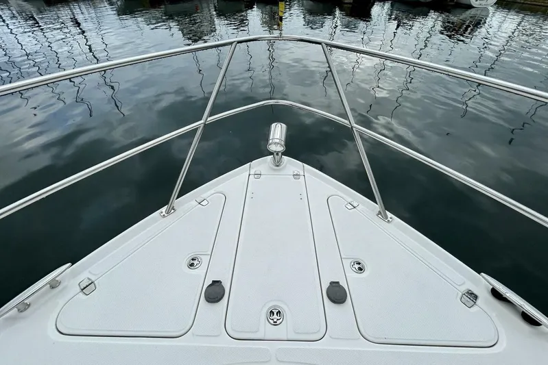  Yacht Photos Pics Bow view of 2011 Regal 38 Express yacht docked on calm water.