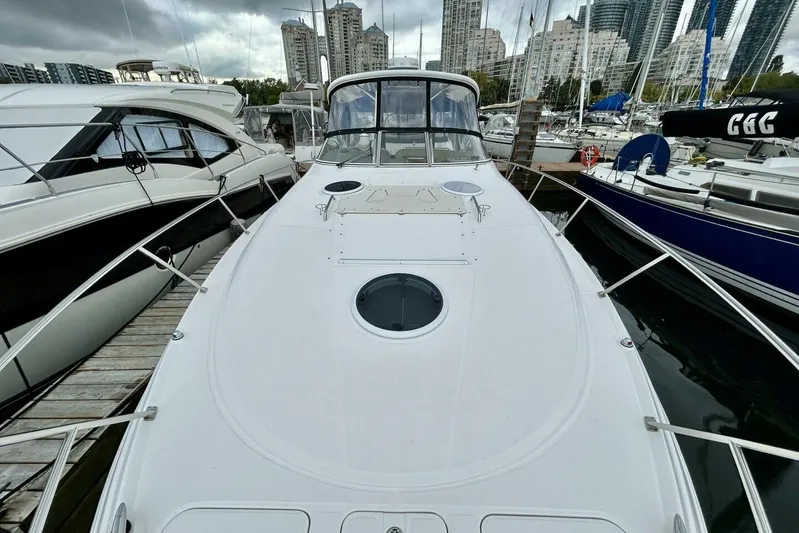  Yacht Photos Pics 2011 Regal 38 Express yacht docked in marina, surrounded by other boats and city skyline.