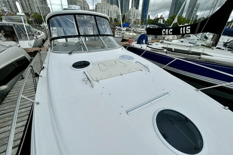  Yacht Photos Pics 2011 Regal 38 Express yacht docked in marina, surrounded by other boats and cityscape.