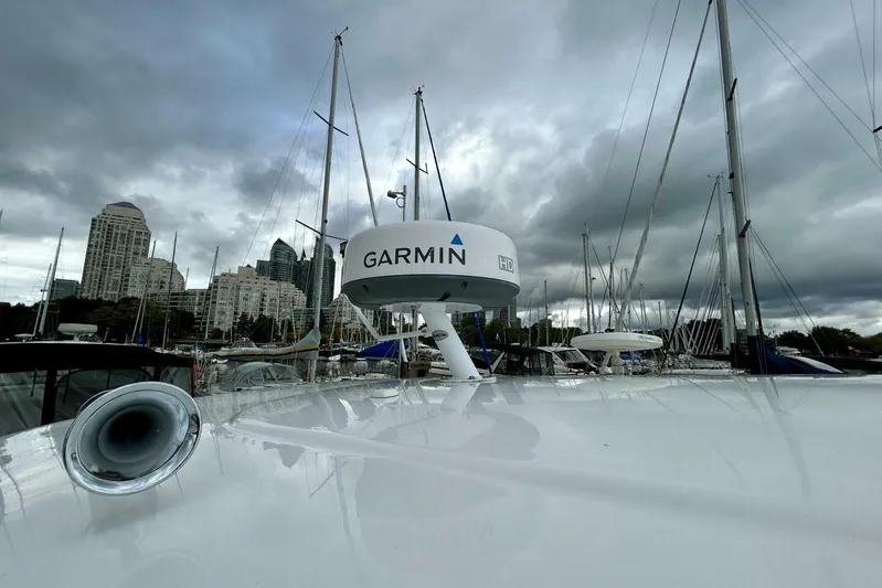  Yacht Photos Pics 2011 Regal 38 Express yacht with Garmin radar, docked under cloudy skies.