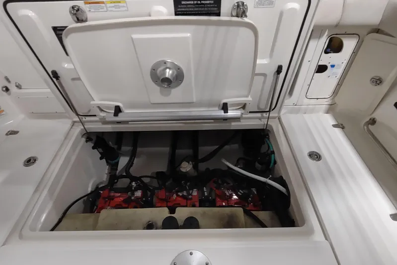  Yacht Photos Pics Open engine compartment of 2015 Boston Whaler 285 Conquest boat, showcasing internal components.