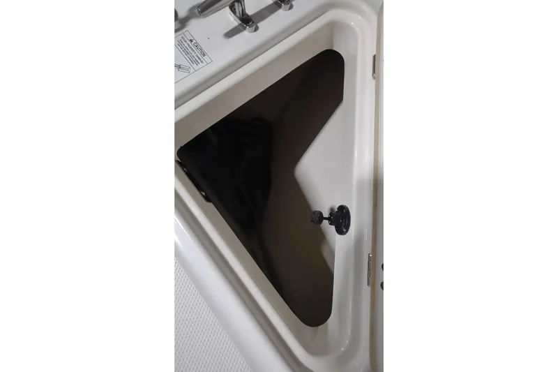  Yacht Photos Pics 2015 Boston Whaler 285 Conquest storage compartment with latch, showcasing interior space.