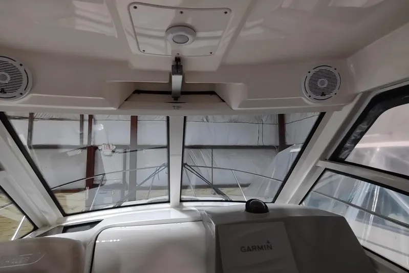  Yacht Photos Pics 2015 Boston Whaler 285 Conquest interior with Garmin navigation system and speakers.