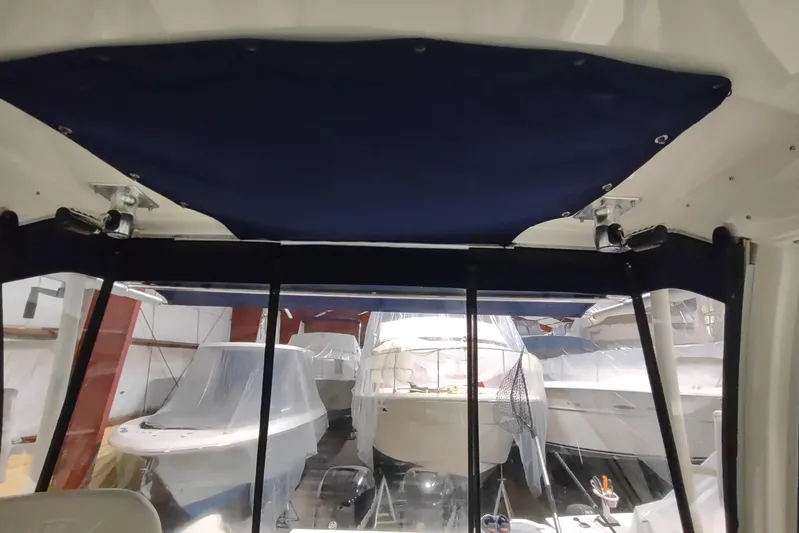  Yacht Photos Pics Interior view of a 2015 Boston Whaler 285 Conquest in storage, surrounded by covered boats.