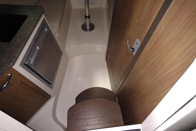  Yacht Photos Pics 2015 Boston Whaler 285 Conquest cabin interior with wood accents and compact design.
