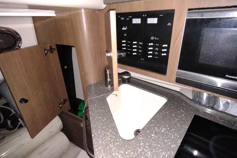  Yacht Photos Pics 2015 Boston Whaler 285 Conquest interior with sink, microwave, and control panel.