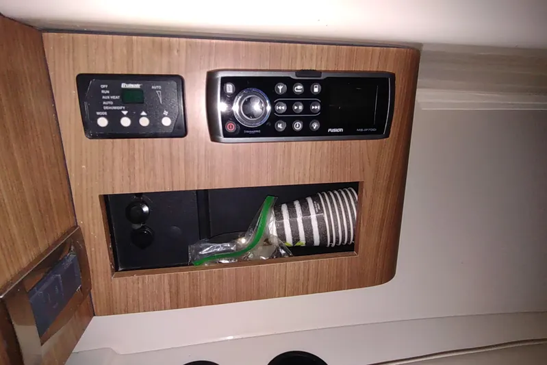  Yacht Photos Pics 2015 Boston Whaler 285 Conquest interior with control panel and storage compartment.