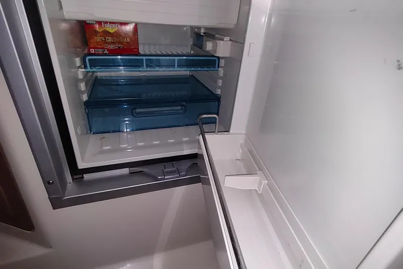  Yacht Photos Pics Open refrigerator on 2015 Boston Whaler 285 Conquest boat, showing coffee and storage drawers.