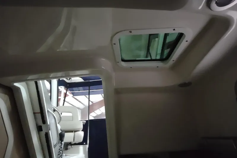  Yacht Photos Pics Interior cabin view of 2015 Boston Whaler 285 Conquest boat with overhead hatch.