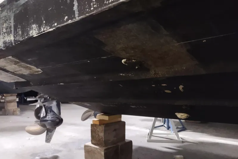  Yacht Photos Pics 2015 Boston Whaler 285 Conquest boat hull on blocks in a workshop.