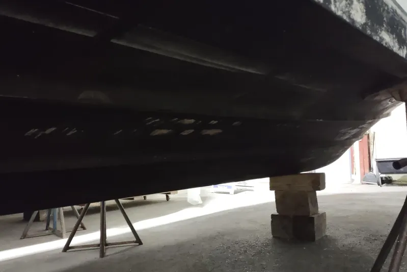  Yacht Photos Pics 2015 Boston Whaler 285 Conquest boat hull on stands in a garage.