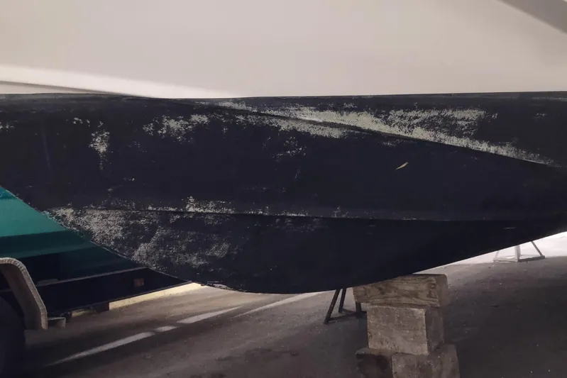  Yacht Photos Pics 2015 Boston Whaler 285 Conquest boat hull on blocks, showing wear and marine growth.