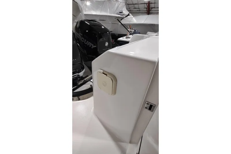  Yacht Photos Pics 2015 Boston Whaler 285 Conquest boat with Mercury engine in a storage facility.