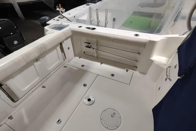  Yacht Photos Pics 2015 Boston Whaler 285 Conquest boat interior, featuring spacious deck and storage compartments.