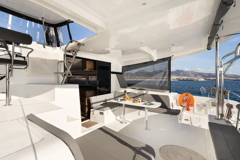 Yacht Photos Pics Luxurious 2020 Lagoon 42 catamaran with spacious deck, dining area, and ocean view.