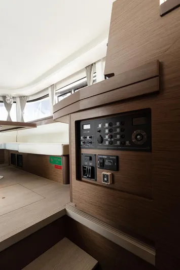 Yacht Photos Pics Interior of 2020 Lagoon 42 yacht with control panel and modern wood finish.