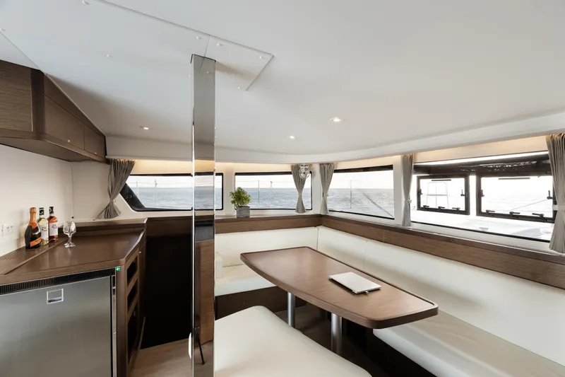  Yacht Photos Pics Luxurious interior of 2020 Lagoon 42 catamaran with elegant dining area and ocean view.