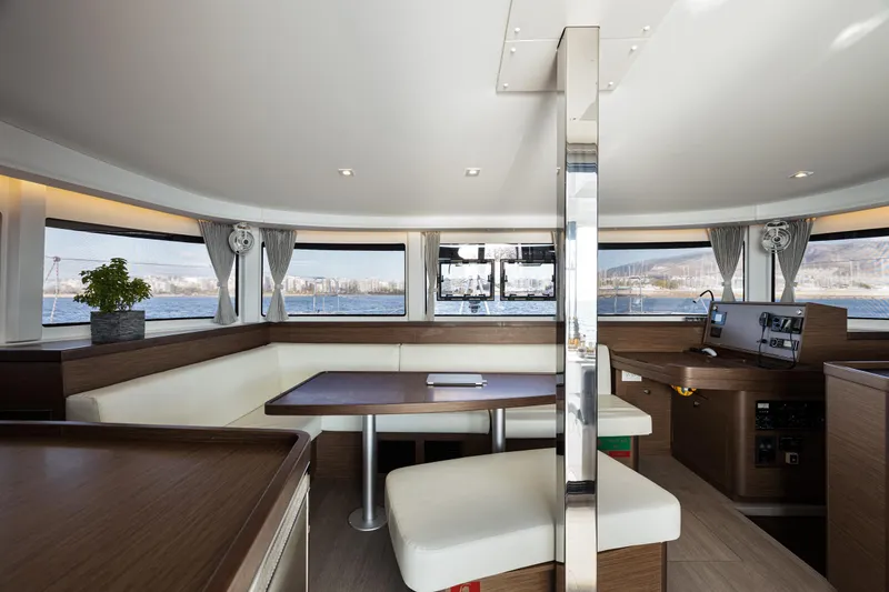  Yacht Photos Pics Interior of 2020 Lagoon 42 catamaran with modern seating and panoramic windows.
