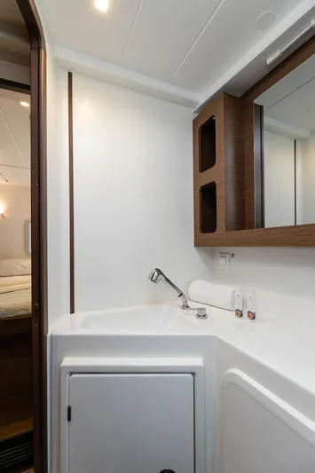  Yacht Photos Pics Modern bathroom interior of 2020 Lagoon 42 yacht with sleek fixtures and wooden accents.