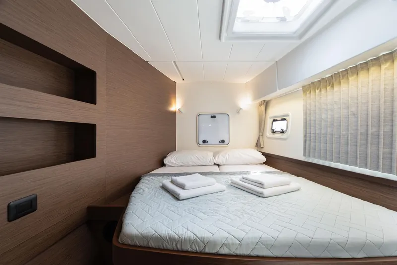  Yacht Photos Pics Luxurious cabin interior of 2020 Lagoon 42 catamaran with cozy bed and modern design.