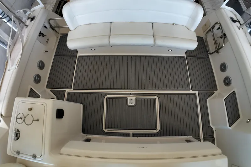 Sun Baked Yacht Photos Pics 1999 Tiara Yachts 3500 Express boat interior with white seating and sleek deck design.