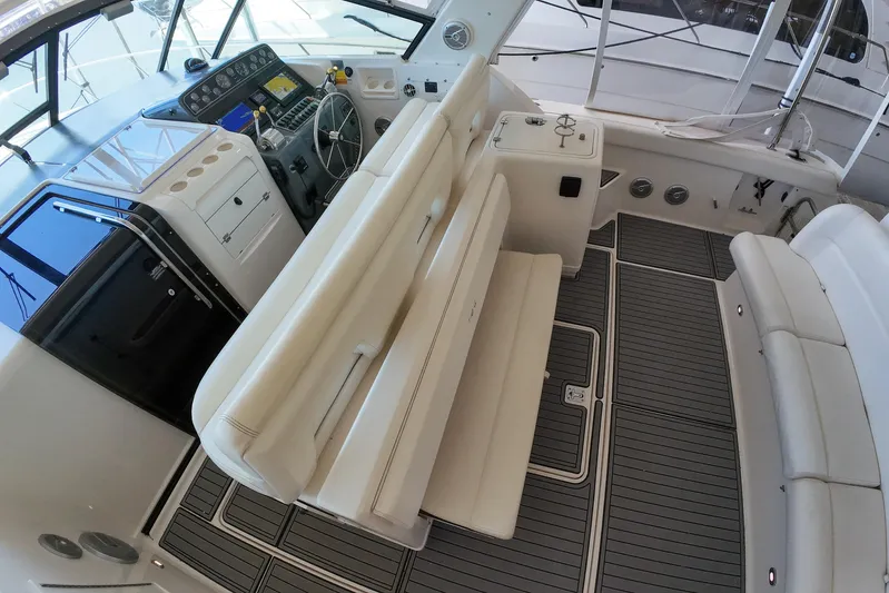 Sun Baked Yacht Photos Pics 1999 Tiara Yachts 3500 Express interior with helm, seating, and modern dashboard.