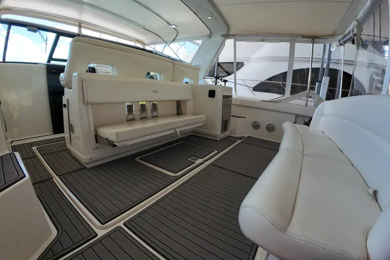 Sun Baked Yacht Photos Pics 1999 Tiara Yachts 3500 Express interior with white seating and sleek design.