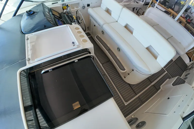 Sun Baked Yacht Photos Pics 1999 Tiara Yachts 3500 Express interior with white seating and sleek dashboard.